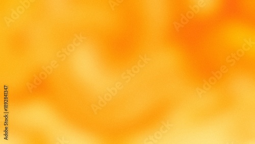 Vibrant orange and yellow abstract grainy gradient background with soft texture.