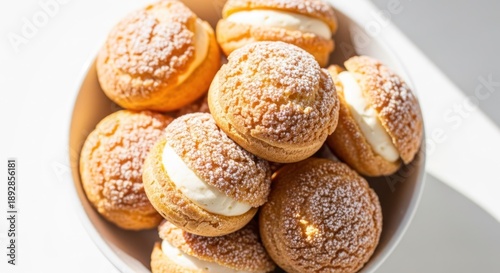 Wallpaper Mural Cream puffs dusted with powder sugar in a white bowl under sunlight Torontodigital.ca