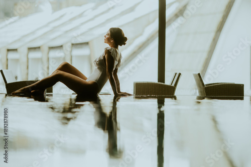Woman relaxing by the pool ...