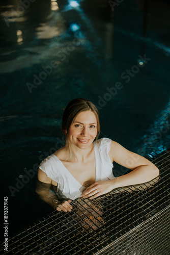 Woman relaxing in indoor po...