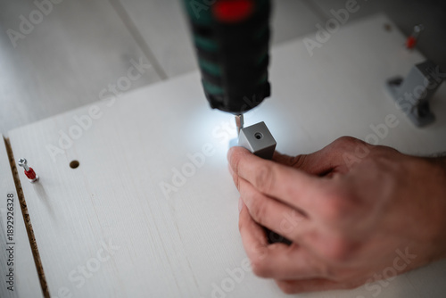 Wallpaper Mural Hand assembling furniture using electric screwdriver at home Torontodigital.ca