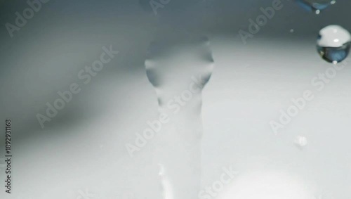 Flowing Water: Capturing the essence of purity and refreshment, a stream of pristine water cascades downwards, creating a soothing and tranquil visual.