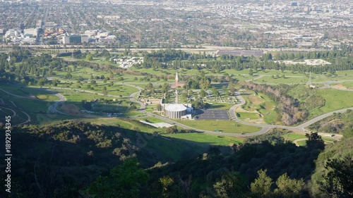 Wide shot from a high viewpoint showing the sprawling cityscape of Los Angeles and Glendale with the famous Forest Lawn Memorial Park in the foreground.