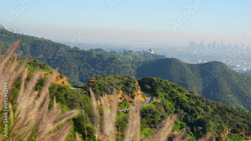 Wide, sweeping panoramic video of the vast Los Angeles cityscape, shot from a trail in Griffith Park. The view covers Glendale and Burbank on a hazy day.