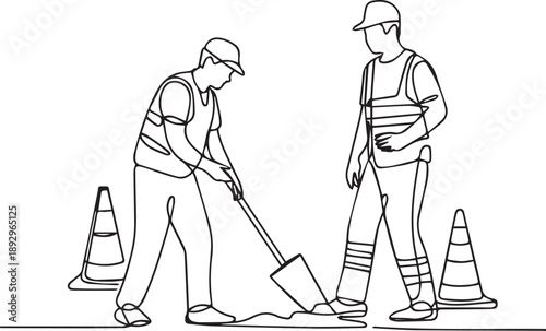 Two workers in safety gear shoveling material between traffic cones on a road construction site from a side view