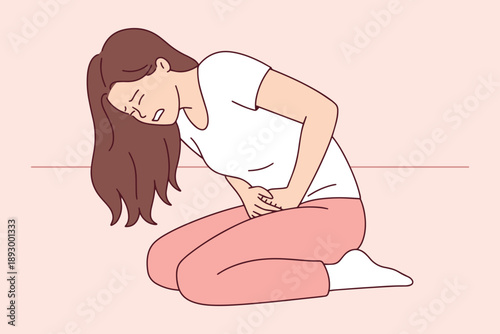 Young woman kneeling on the floor and holding her painful stomach. Concept of acute physical distress from endometriosis menstruation or intestinal issues causing weakness