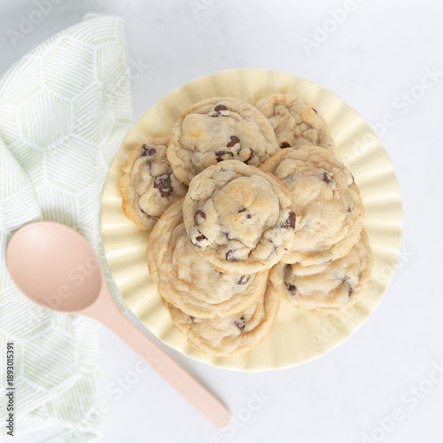 Cookies on a yellow plate with pink spoon