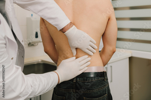 Photography Patient undergoing renal palpation by urologist to evaluate kidney pain