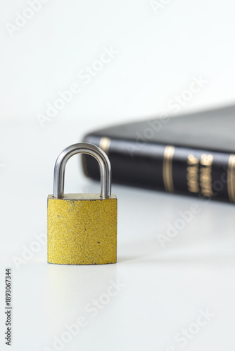 Vászonkép Golden padlock and holy bible book on white background