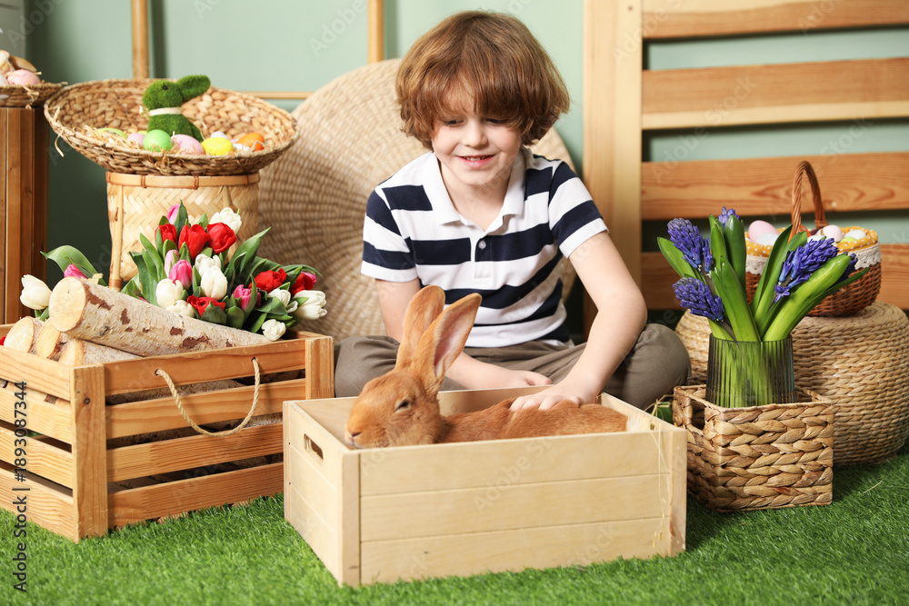 © New Africa - Little boy with cute Easter bunny in wooden crate indoors © New Africa - Little boy with cute Easter bunny in wooden crate indoors