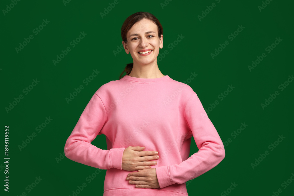 Fototapeta premium Woman with healthy stomach on green background