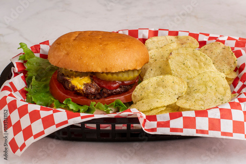 hamburger with  a side of potato chips,