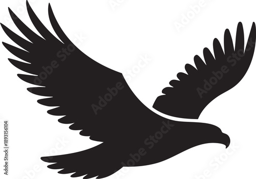 A black silhouette of an eagle in mid flight with wings spread wide
