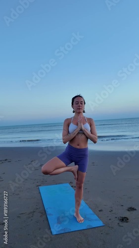 Lesbian woman practicing yoga meditation on the beach