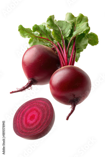 Two beets and a sliced beet, showing vibrant red rings with leafy greens