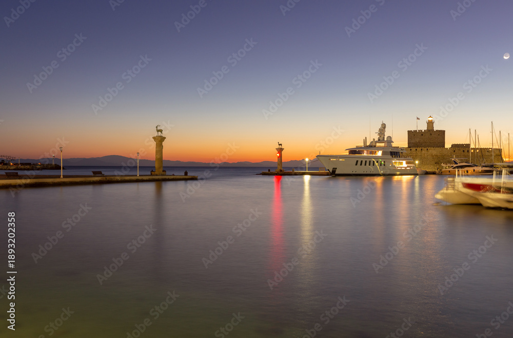 Fototapeta premium Sunrise at the Mandraki Harbor in Rhodes, Greece