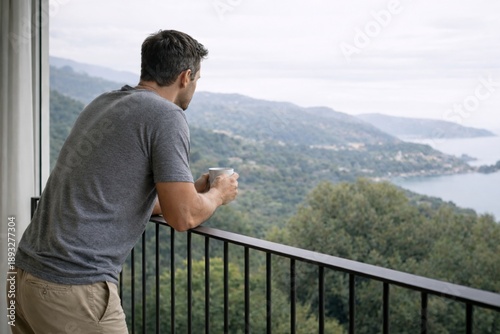Confident Man Relaxing on Balcony with Coffee and Mountain Landscape View