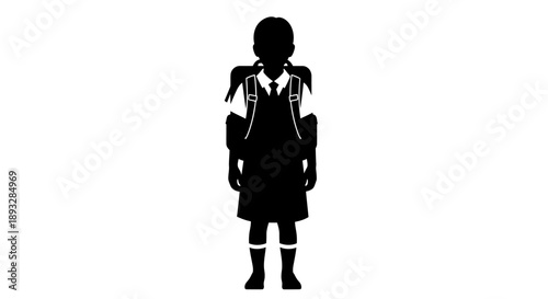Silhouette of a young school girl wearing a uniform and backpack.