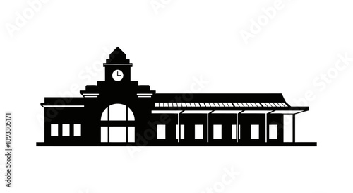 Silhouette of a historic train station building with a clock tower.