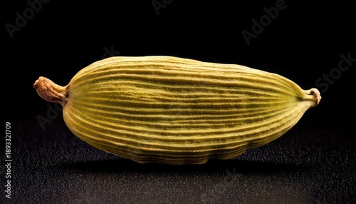 Wallpaper Mural Close-up of a single cardamom pod against a black background. Torontodigital.ca