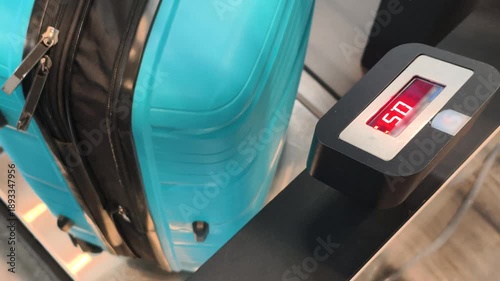 Airport Luggage Scale shows weight of blue suitcase. Check of Airport Luggage Scale is part of travel safety. Using Airport Luggage Scale helps to follow baggage allowance rules.