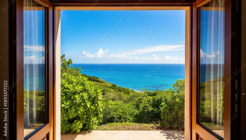 Fototapeta premium Seaview Through an Open Door: A mesmerizing view unfolds through an open doorway, revealing a breathtaking panorama of the vast ocean meeting a vibrant, green landscape.
