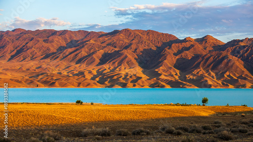 Photography Amazingly picturesque morning landscape of Tien Shan red mountains and Lake Bartogay, Nature of Kazakhstan near Almaty