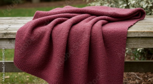Cozy Maroon Knitted Throw Blanket on Wooden Bench