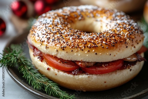 Bagel topped with tomato & cheese on a plate.