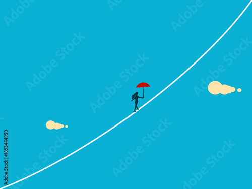businesswoman with an umbrella walks a tightrope