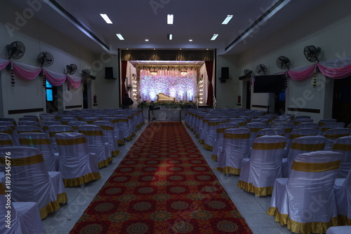 Indian stage decoration with multi color flowers, props and lights. wedding stage decoration
