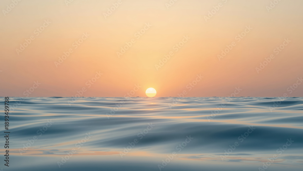 Fototapeta premium Serene sunset over calm sea with golden horizon and soft pastel sky