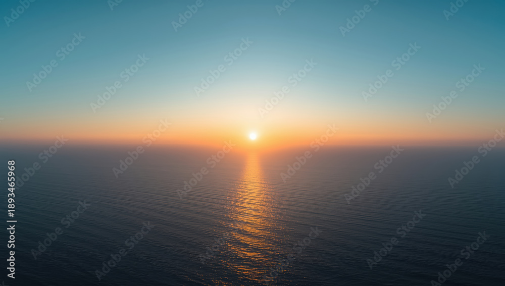 Fototapeta premium Serene sunset over calm ocean with golden reflection on water