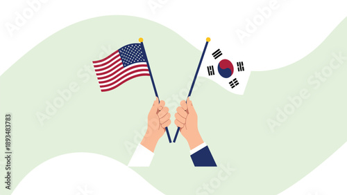 Hands holding American and South Korean flags to symbolize strong international relations and diplomatic cooperation.