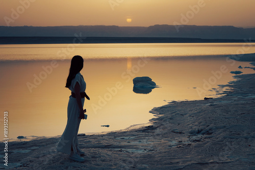 Woman watching sunset at Dead Sea in Jordan
