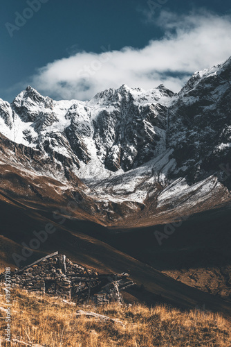 autumn scenery with snowy heights in the background