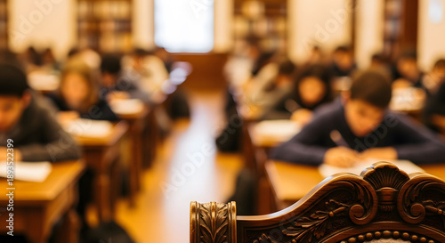 Ornate carved wooden chair backrest in foreground with blurred s