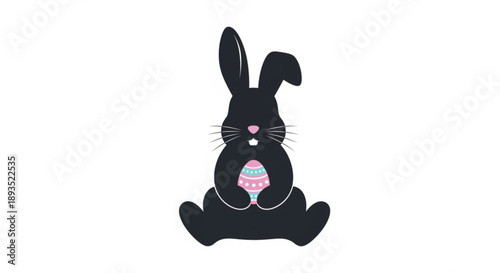 A black cartoon bunny holding an Easter egg in its paws, sitting on the ground, isolated on a plain background.