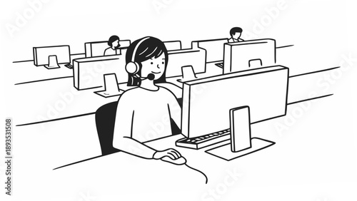 A woman wearing a headset and working on a computer in a busy office environment with cubicles