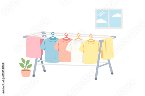 Clothes dry on a rack set up indoors near a window with a view of clouds on a sunny day in a home environment