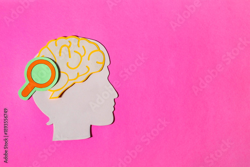 Horizontal Paper Cut Head with Magnifying Glass on Brain