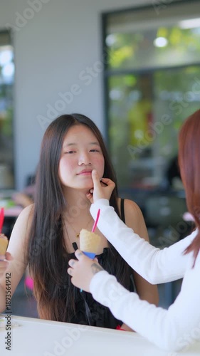 The smiling couple are enjoying ice cream.