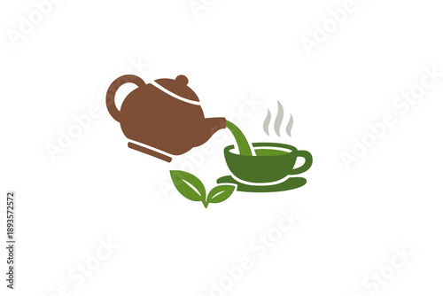 Hot tea is poured from a brown teapot into a green teacup with steam rising above the cup and leaves beside it