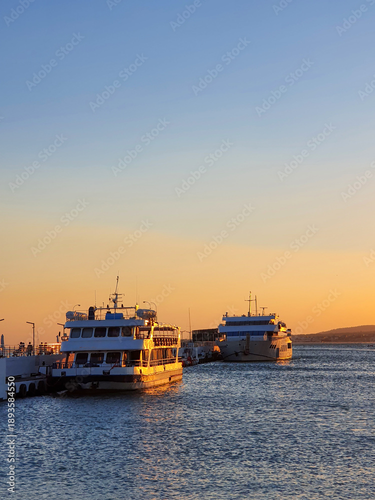 Fototapeta premium Passenger Ferries Docked in Golden Sunset Light