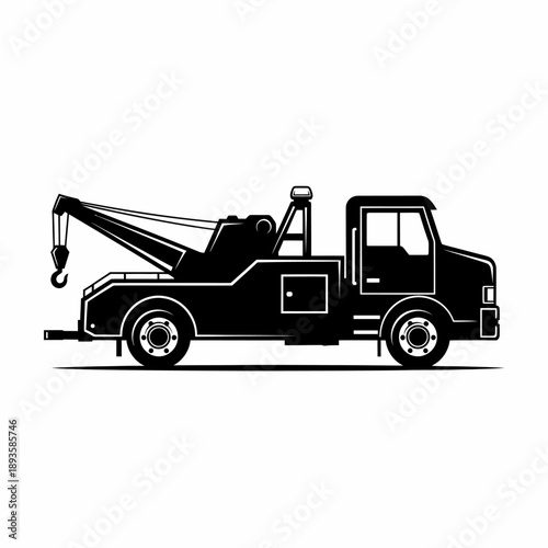 A black and white silhouette illustration of a tow truck, also known as a wrecker, depicted in a side profile view on a white background.