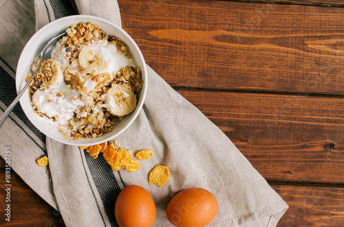 healthy breakfast bowl of yogurt with granola and eggs