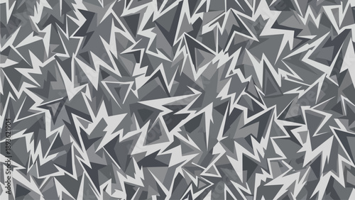 Aerial view of a chaotic geometric pattern of jagged shapes and abstract designs in various shades of gray