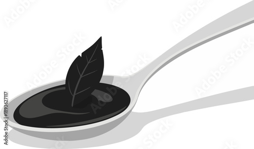 A simple black substance with a dark leaf on a spoon