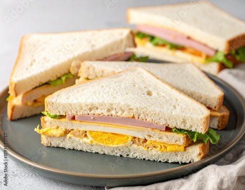Delicious Egg, Cheese, and Ham Sandwiches on Plate