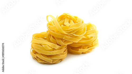 Cuadro en lienzo Uncooked fettuccine nest pasta on white background